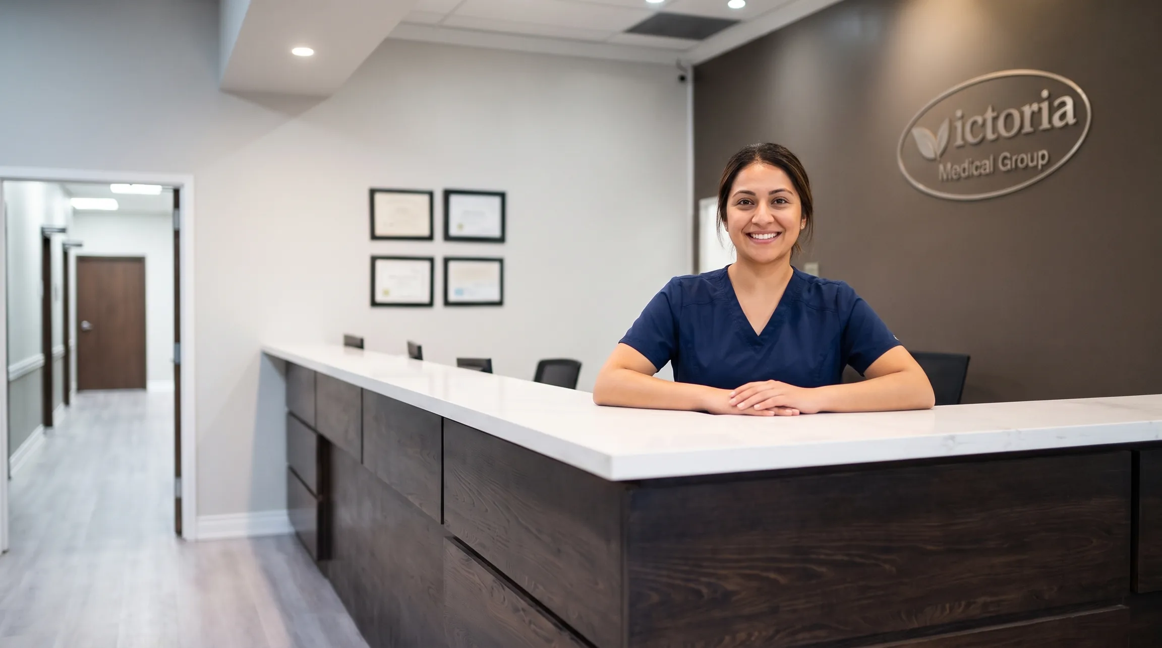 A Victoria Medical Group receptionist smiling at the front desk